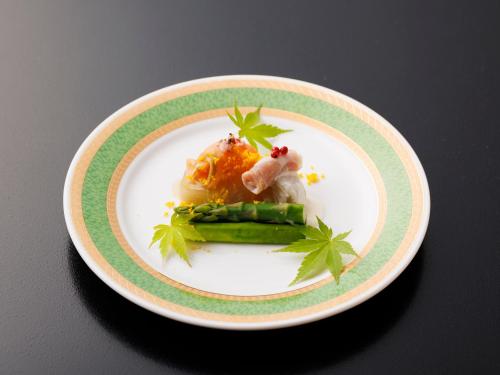 a plate of food on a black table with a plate of food at Wakamiro in Hokuto