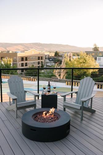 two chairs and a fire pit on a deck at Hotel Windrow Downtown Ellensburg in Ellensburg
