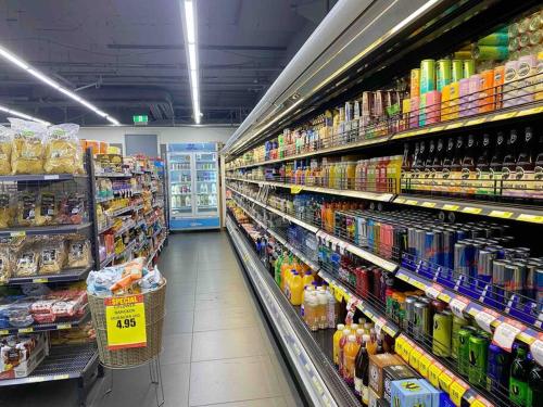 a store aisle of a grocery store with lots of products at So Unique! Collins Street Vibe 2B2B in Melbourne