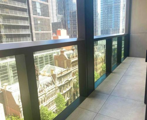 a view of a city from a window in a building at So Unique! Collins Street Vibe 2B2B in Melbourne