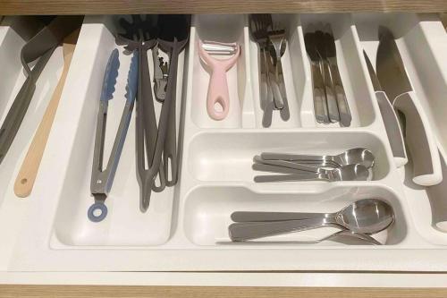 a white tray with utensils in a drawer at So Unique! Collins Street Vibe 2B2B in Melbourne