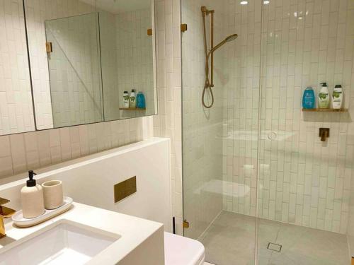 a bathroom with a shower and a toilet and a sink at So Unique! Collins Street Vibe 2B2B in Melbourne