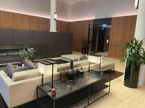 a living room with a couch and a glass table at So Unique! Collins Street Vibe 2B2B in Melbourne