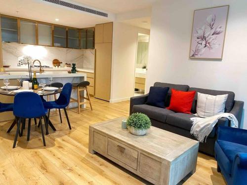 a living room with a couch and a table at So Unique! Collins Street Vibe 2B2B in Melbourne