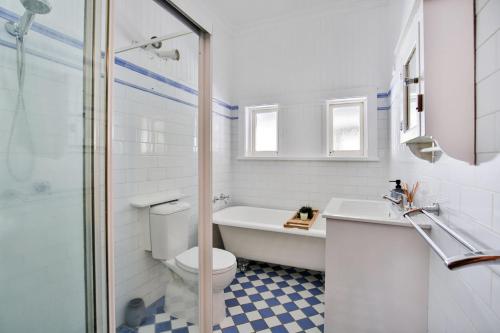 a bathroom with a toilet and a sink and a shower at Bali Huts in Nowra
