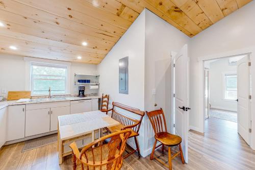 a kitchen and dining room with a table and chairs at Shorelands, Unit 44-3 in Kennebunk