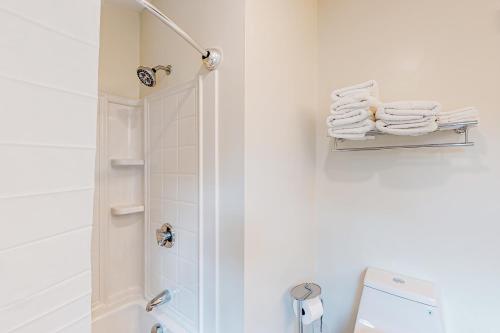 a bathroom with a shower and a toilet and towels at Shorelands, Unit 44-3 in Kennebunk