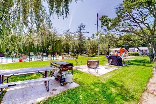 a picnic table and a grill in a park at Shorelands, Unit 44-3 in Kennebunk