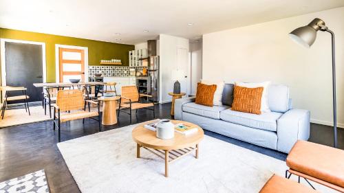 a living room with a couch and a table at Contemporary Front House with Shared Patio in Long Beach