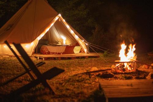 a tent with a fire in front of it at night at Colorado Glamping in Montevideo
