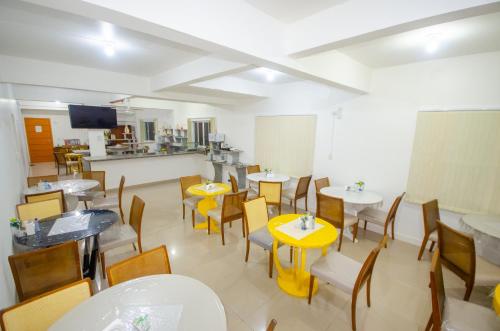 a restaurant with tables and chairs and a kitchen at Hotel Penha in Penha