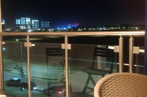 a balcony with a view of a city at night at Down town new El alamein in El Alamein