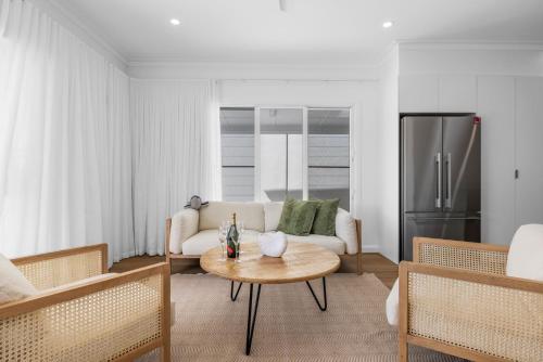 a living room with a couch and a table at Nan's Place in Woolgoolga