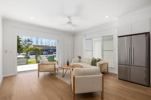 a living room with a couch and a table at Nan's Place in Woolgoolga