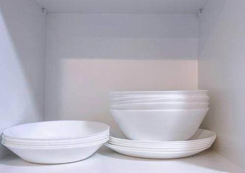 three bowls and plates sitting on a shelf at TheSun #3BR #PISA #FTZ #FamilyStay #USM in Bayan Lepas