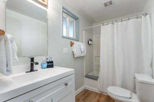 a white bathroom with a sink and a toilet at Tidal House 2 in Ocean Shores