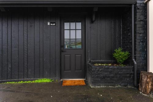 a black front door of a black house at Tidal House 2 in Ocean Shores