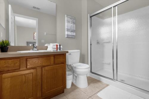 a bathroom with a shower and a toilet and a sink at 3 Bedrooms 25 Bathrooms Encantada 3122 Yl in Orlando