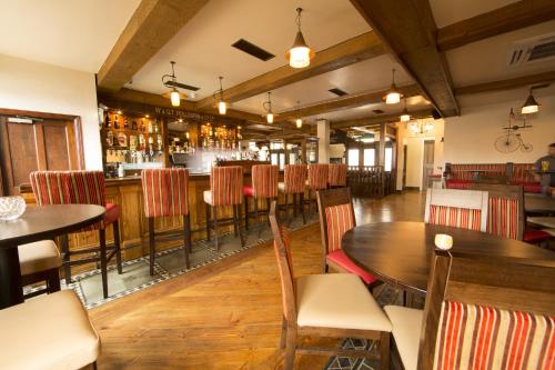 a restaurant with tables and chairs and a bar at Riverside Hotel in Sligo
