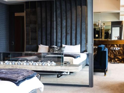 a bedroom with two beds and a glass wall at Emporium Hotel South Bank in Brisbane