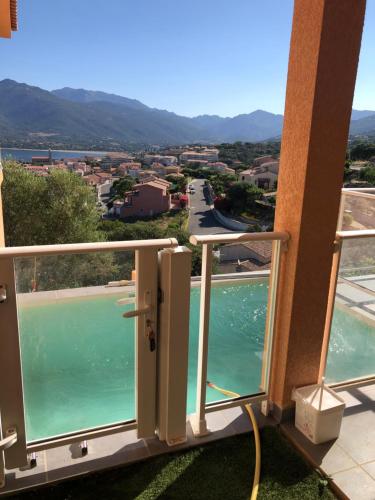 a balcony with a view of a body of water at Casa a cucina in Propriano
