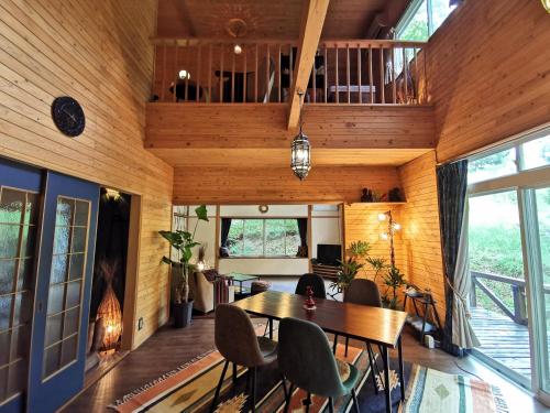 a dining room with a table and chairs at 星空に包まれる 森の隠れ家　Amrita Lodge ~stay & retreat~ in Kirishima