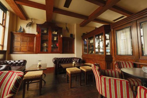 a restaurant with couches and tables and chairs at Riverside Hotel in Sligo
