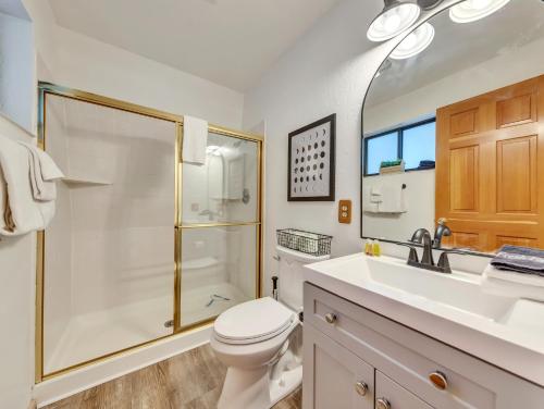 a bathroom with a shower and a toilet and a sink at Moonlight Ridge in Duck Creek Village