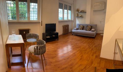 a living room with a table and chairs and a couch at PARIOLI LUXURY HOME in Rome