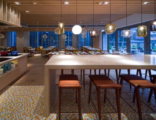 a large dining room with a large table and chairs at Hotel Indigo Hong Kong Island by IHG in Hong Kong