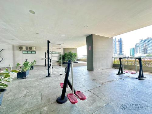 a gym with pink slippers on the floor in a building at SKS Pavillion Residences by Stayrene in Johor Bahru