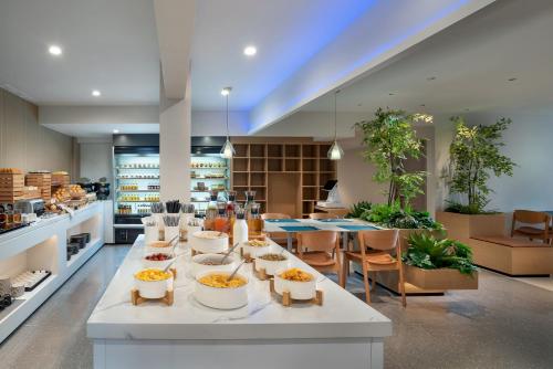 a kitchen with a table with bowls of food on it at CYBO Station Luohu Shenzhen in Shenzhen