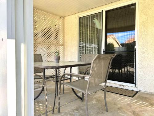 a patio with a table and chairs on a balcony at Silver Sands Den in Hemet