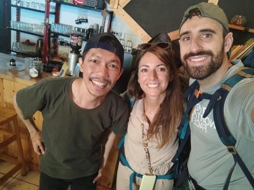two men and a woman posing for a picture at CoffeeBunk Hostel in Tangerang