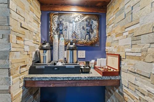 a counter in a room with a stone wall at Desert Rose Resort & Cabins in Bluff