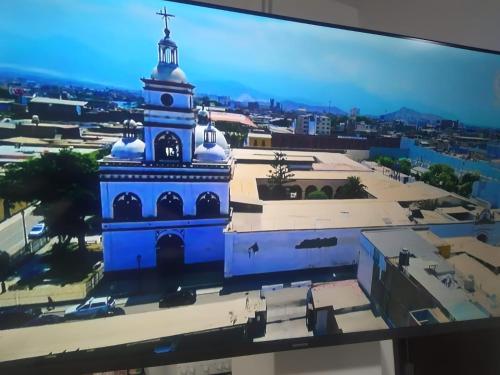 a view of a church with a blue building at Ambigua Hospedaje in Trujillo