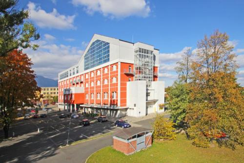 an aerial view of a building with a parking lot at Hotel Spolcentrum in Svit