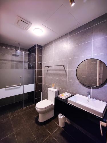a bathroom with a toilet and a sink and a mirror at Studio suite nearby Lost World of Tambun in Tambun