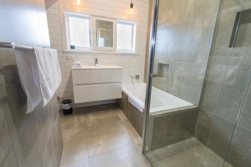 a bathroom with a shower and a sink at Sovereign Park Motor Inn in Ballarat