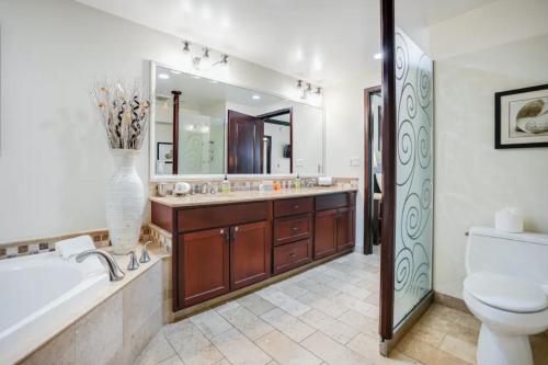 a bathroom with a tub and a toilet and a sink at Condos in Waipouli Beach Resort in Kapaa