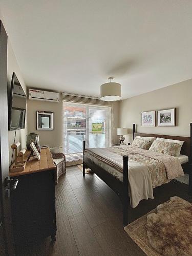 a bedroom with a large bed and a window at Luxury Apartment in Rzeszów