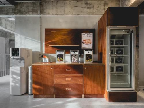 a kitchen with a wooden cabinet and a refrigerator at Hotel Mokozoyo in George Town