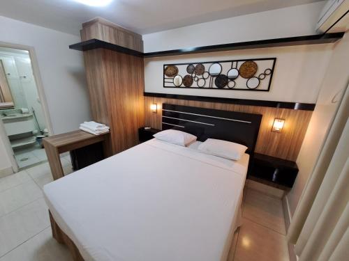 a bedroom with a white bed in a room at Império Romano - Splash e Acqua Park in Caldas Novas