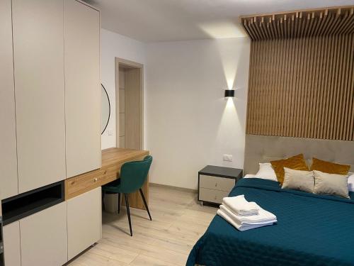 a bedroom with a bed and a desk and a desk at Balkanic Villa Bran in Bran