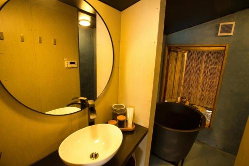 a bathroom with a sink and a mirror at AKIYA nehemiah - Vacation STAY 84870 in Awaji