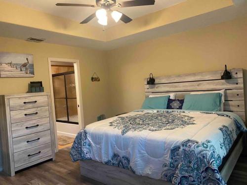 a bedroom with a bed and a ceiling fan at Cozy Coastal Condo in Corpus Christi