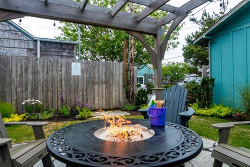 a patio with a fire pit and a pergola at Inn at Haystack Rock in Cannon Beach
