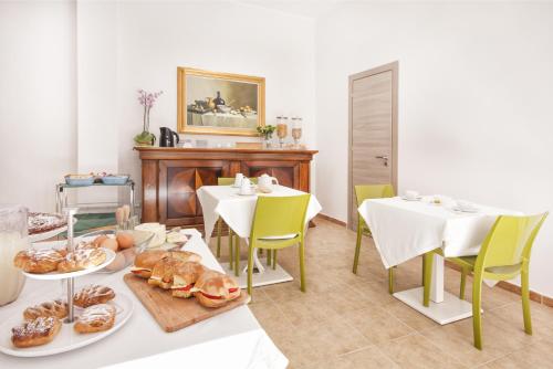 a dining room with two tables with plates of food at B&B La Torre in Castellammare del Golfo