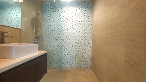 a bathroom with a sink and a shower at La Vista @ Regalia Residence in Kuala Lumpur