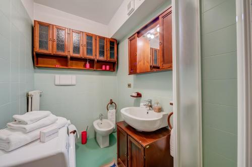 a bathroom with a sink and a toilet at Sestriere Terrace Apt Few Steps From Ski - Happy Rentals in Sestriere